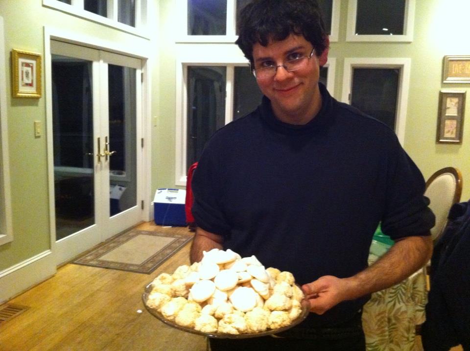 the author holding a plate of passover cookies
