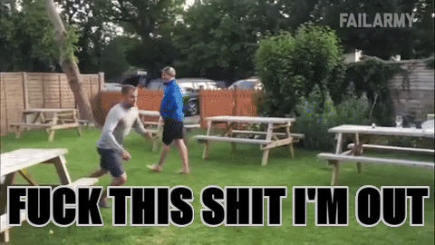 Animated GIF of a man launching himself headfirst through a wooden fence