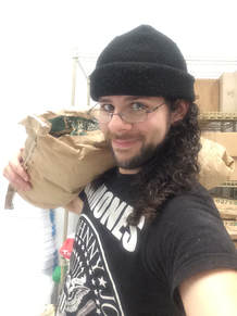 The author with a bag of flour over his shoulder, wearing a Ramones tee.