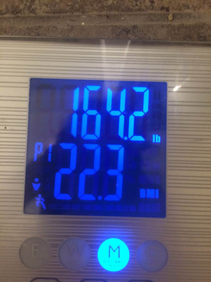 Scale readout indicating 164.2 pounds and a BMI of 22.3