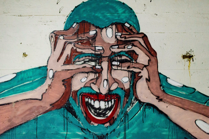 graffiti wall painting of a screaming man