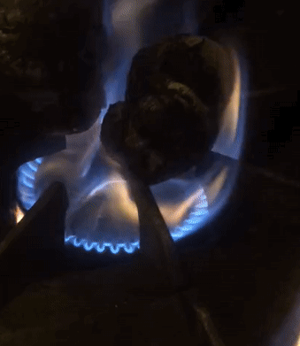 Animated GIF of peppers roasting on a gas burner