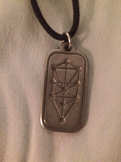 A pewter pendant depicting the sephirot in the Etz Chaim pattern.