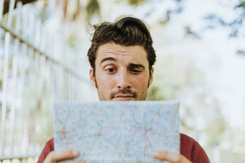 A man looking at a map, confused