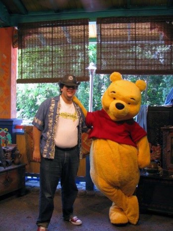 An old picture of the author, standing next to Winnie the Pooh