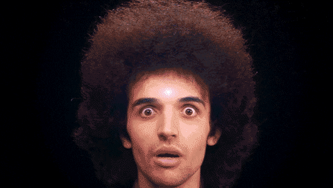 Animated GIF of a young man with an afro and the Big Bang superimposed on his forehead