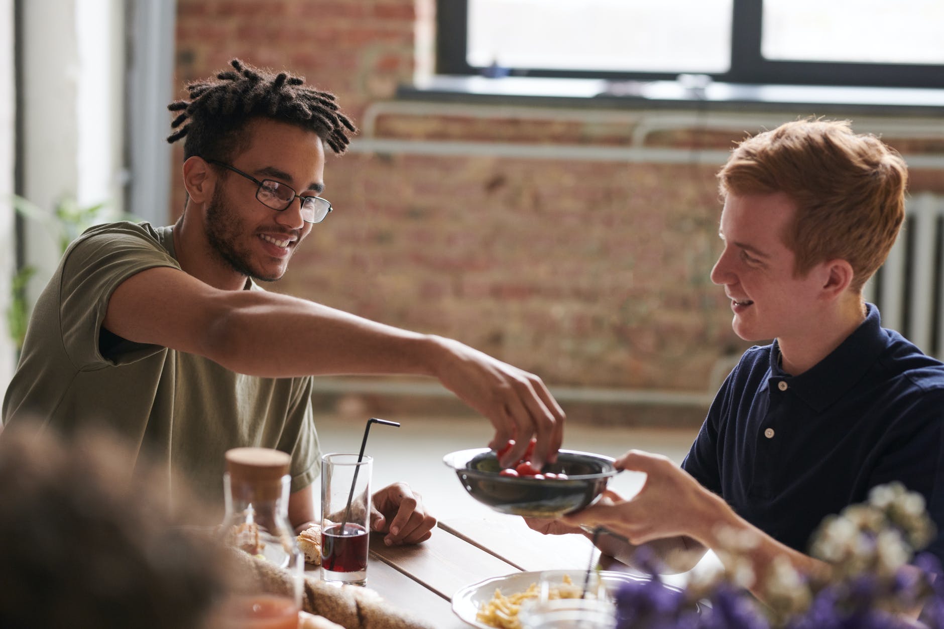 Two young men sharing a meal.