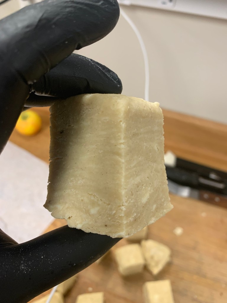 A cube of pie dough with strata of dough and butter clearly visible.